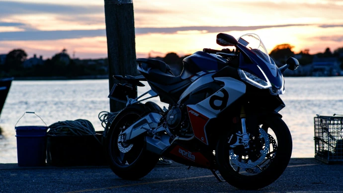 A motorcycle parked next to a body of water